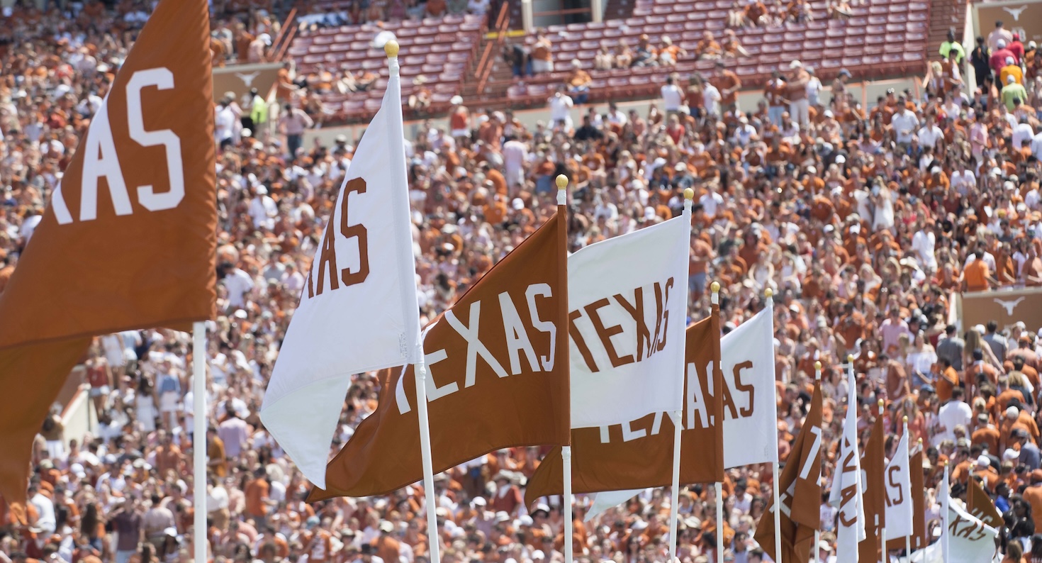 Burnt orange and white flags at Longhorns football game in Austin, Texas