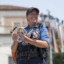 Officer L. Smith of UTPD hands out stickers at student welcome on UT’s Main mall