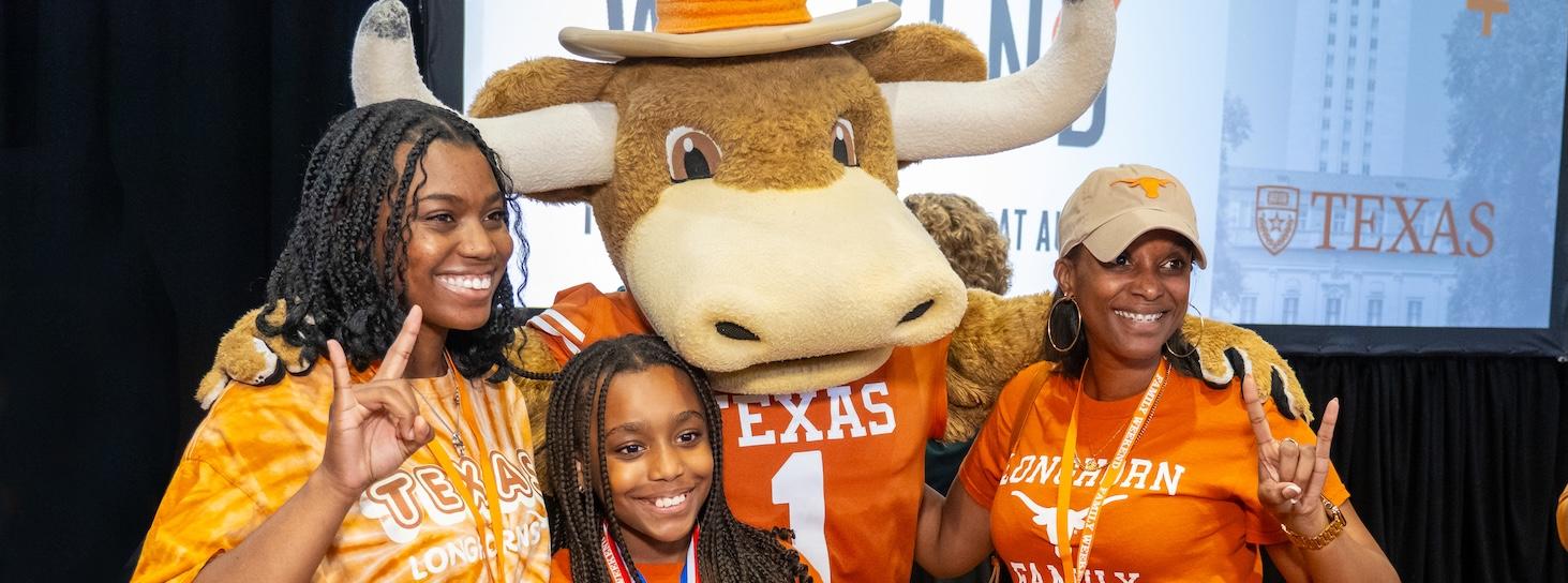 UT Austin's Hook 'Em mascot with three family members at Family Weekend UT Austin's Hook 'Em mascot with three family members at Family Weekend