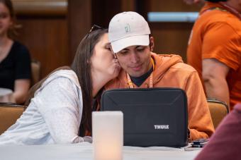 Young man receiving a kiss on the cheek from a young woman