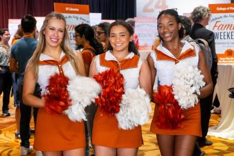 Three cheerleaders with pompoms