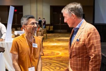 UT Austin President Jay Hartzell chatting with someone