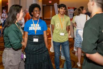 Four people standing and chatting