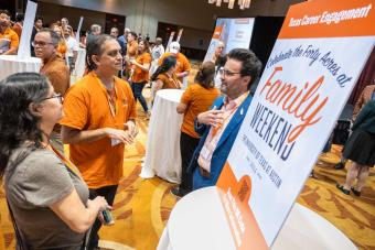 Three people chatting at Texas Career Engagement table