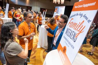 Three people chatting at Texas Career Engagement table