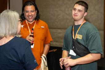 Three people standing and chatting