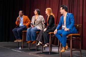 Four panelists seated on stage